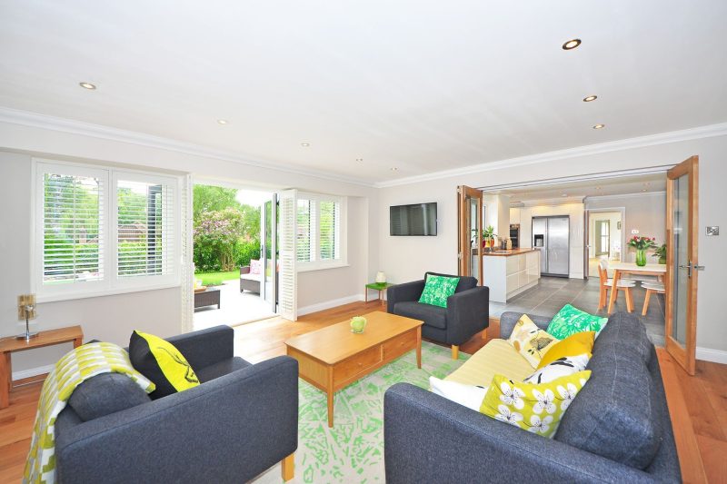 Modern living room with open plan kitchen and garden view