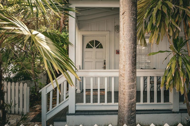 Blog 12 Charming tropical front porch with palm trees and white wood