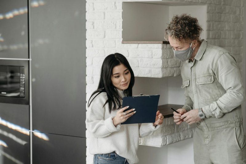 Blog 7 Masked courier and woman interacting indoors