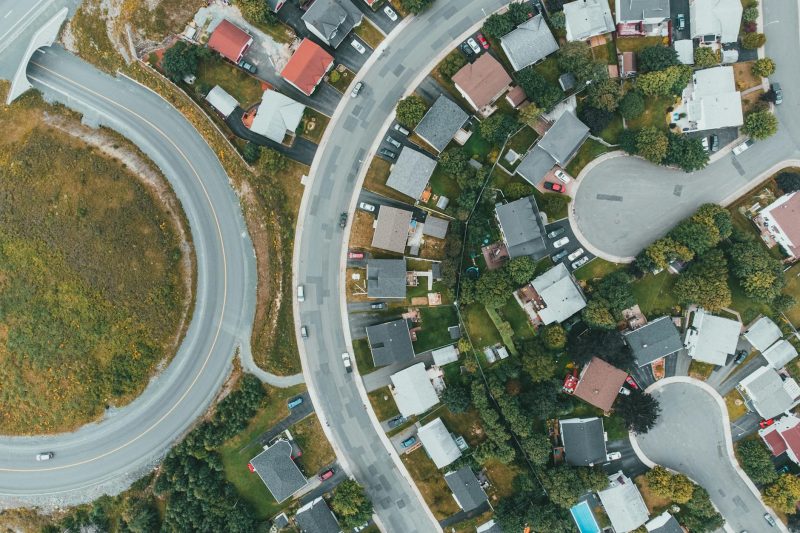 Blog 11 Aerial view of a suburban neighborhood with curved roads