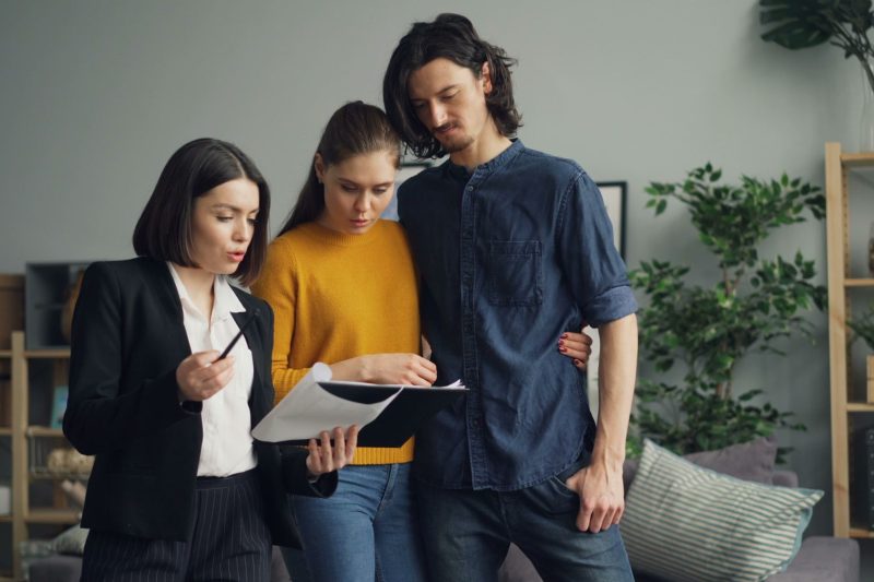 Blog 7 a couple reviewing documents with a real estate agent