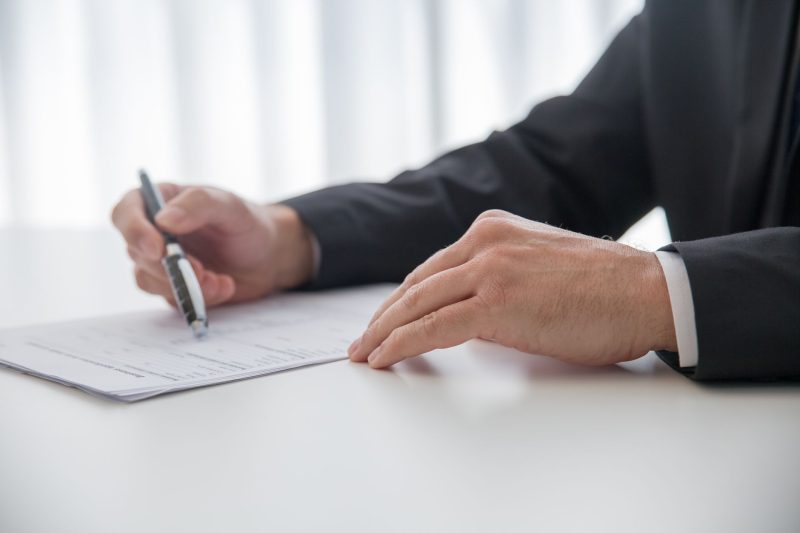 Blog 1 Businessman signing important documents at office desk