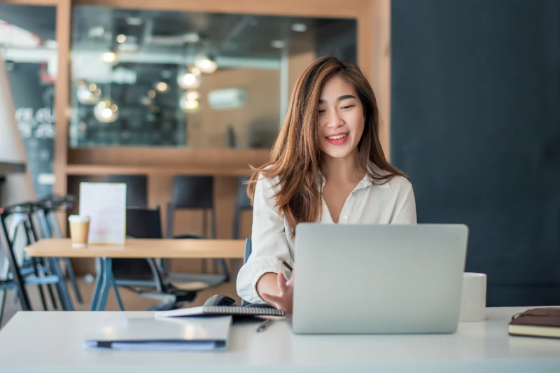 Home 15 Charming asian businesswoman sitting working on laptop in office